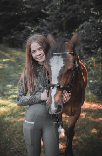 a person standing next to a horse