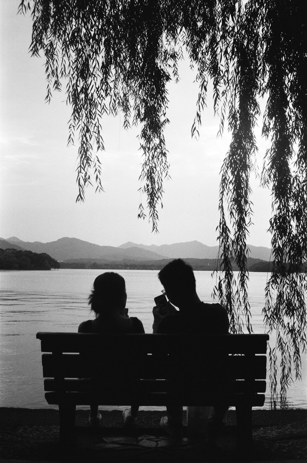 a couple sits on a bench