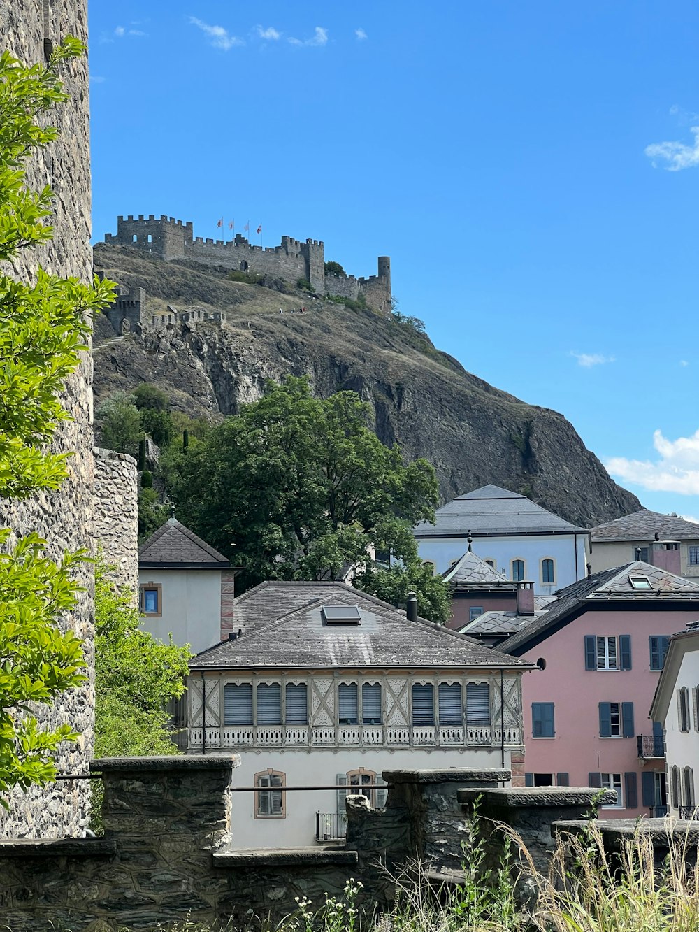 a group of buildings with a hill in the background