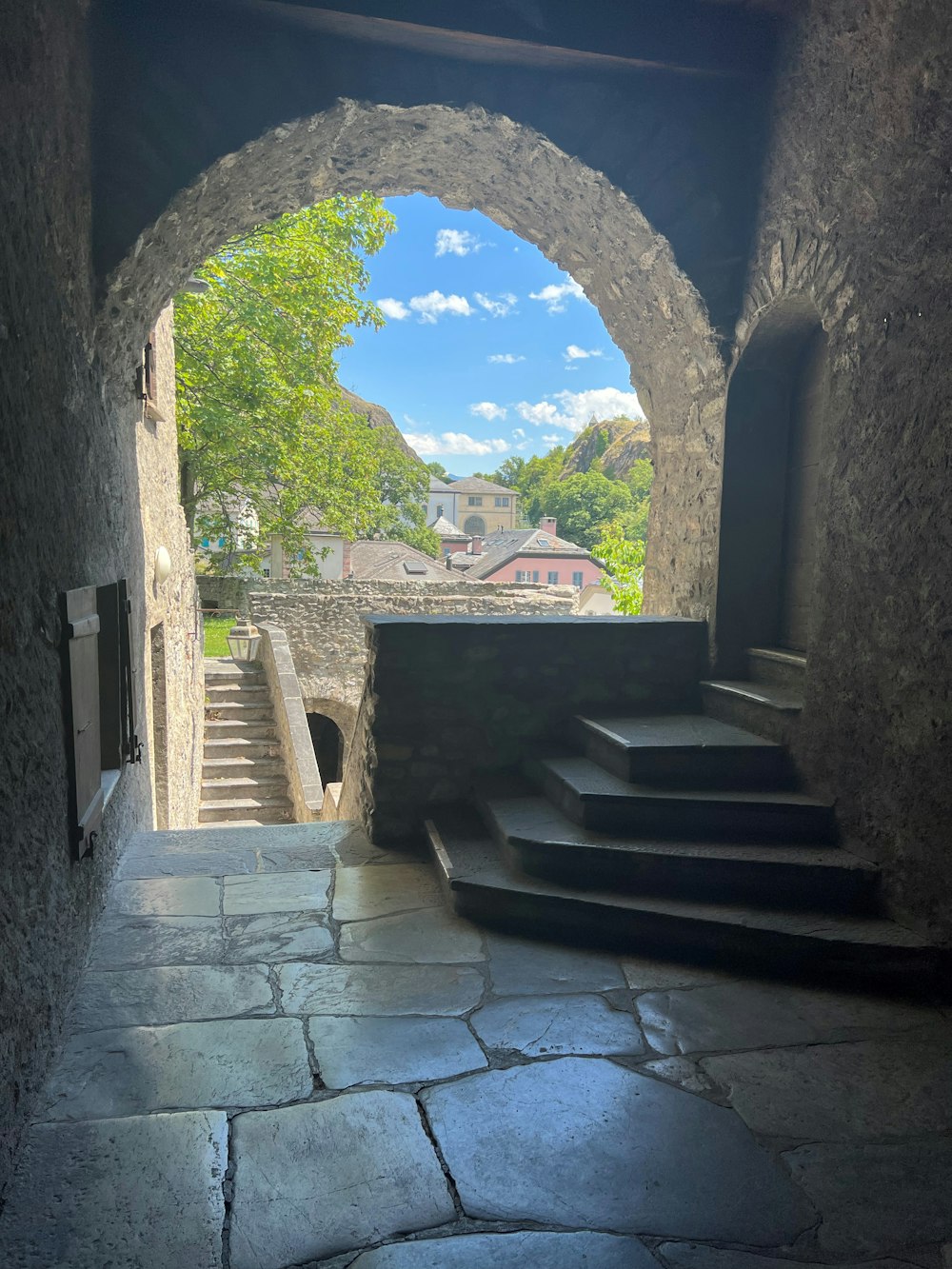 a stone walkway with a stone archway