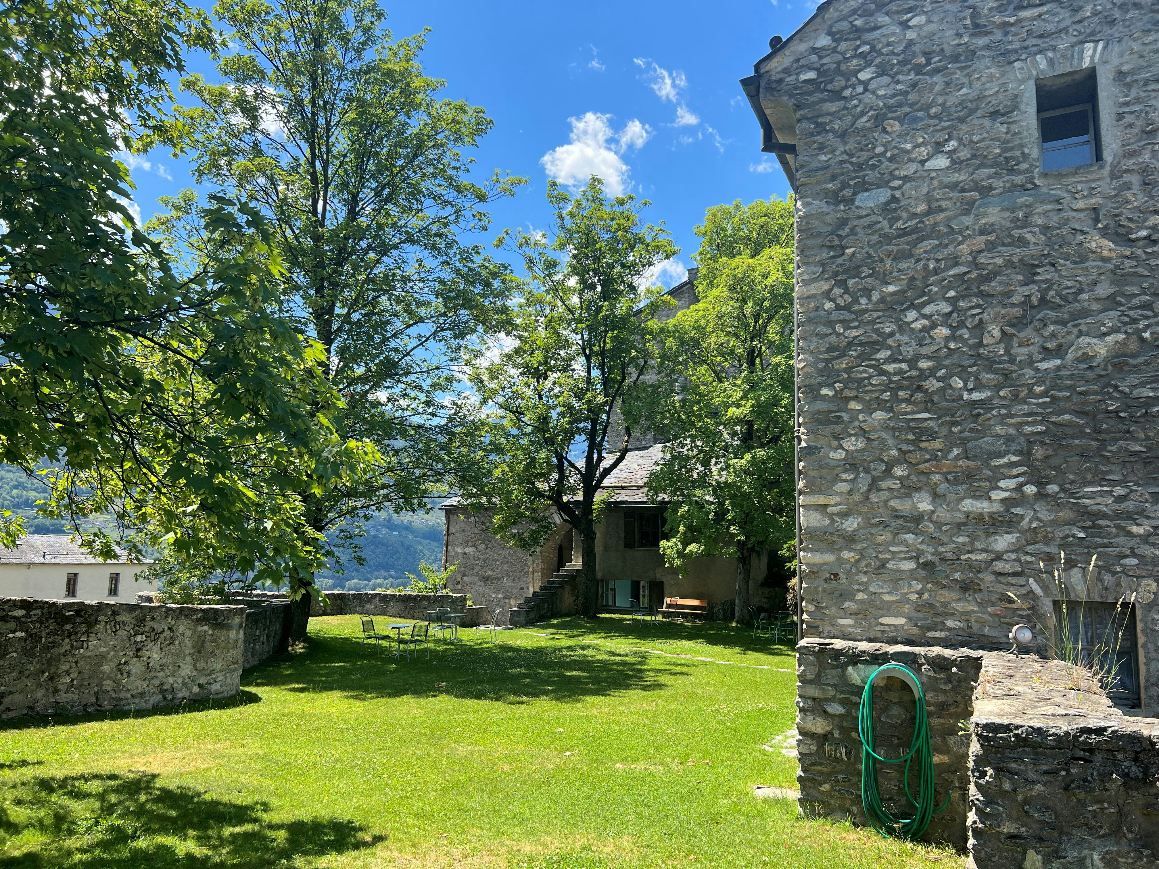 a stone building with a grass yard