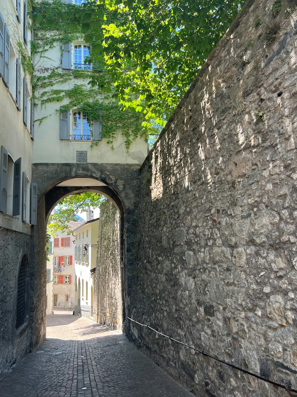 a stone alley between two buildings