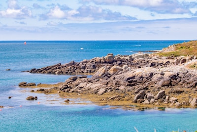 a rocky beach with blue water