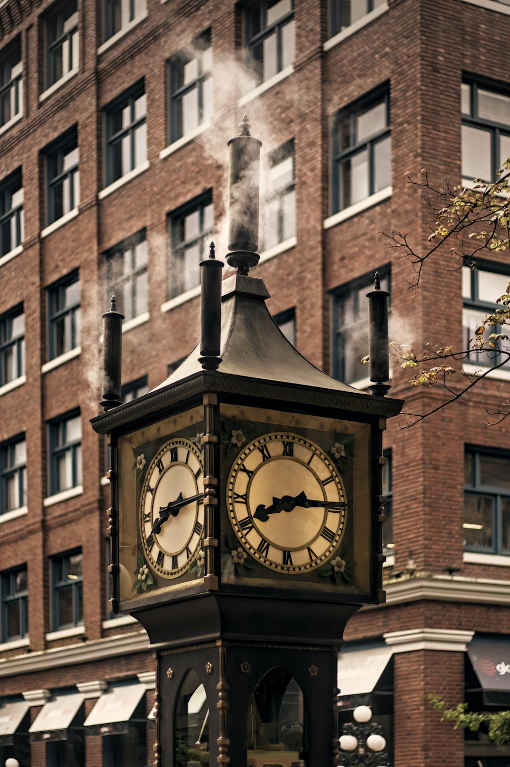 a clock on a pole with Lower East Side Tenement Museum in the background