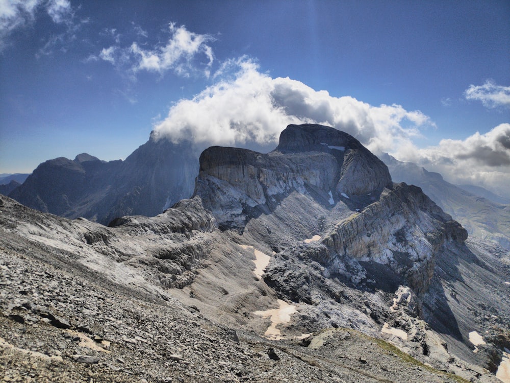 a rocky mountain with a cloud in the sky