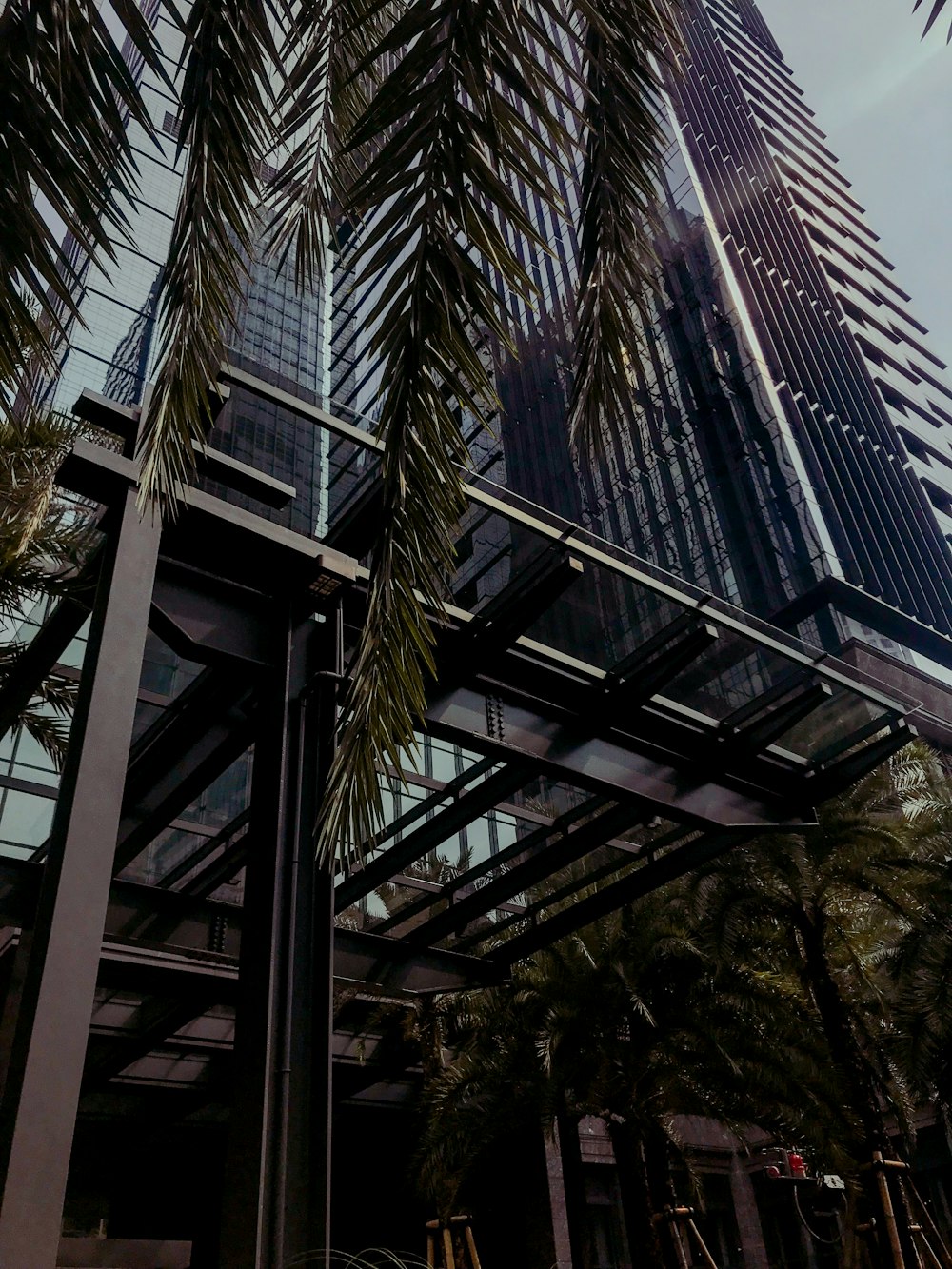 a large metal structure with trees around it