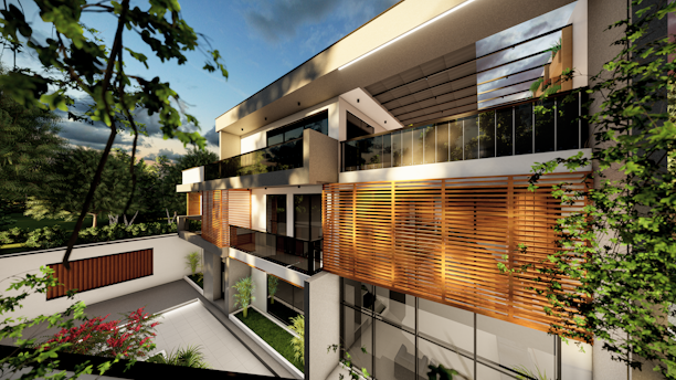 A modern, architectural house with large windows and wooden paneling on the upper floor. The building is surrounded by greenery including trees and shrubs in a well-maintained garden area. The sky is partly cloudy, and there is a warm light cast over the structure, suggesting a serene and comfortable setting.
