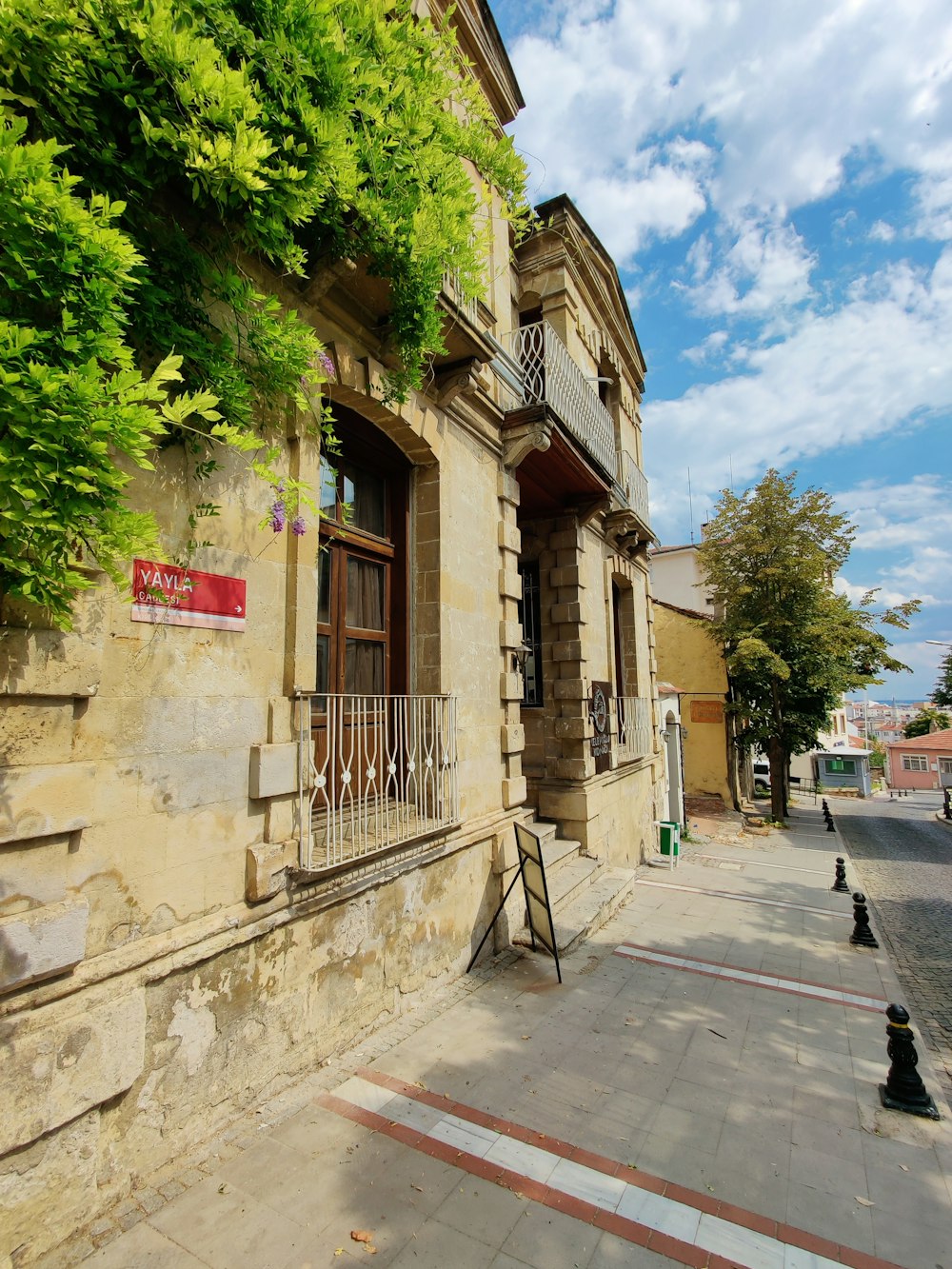 a building with a gate and trees