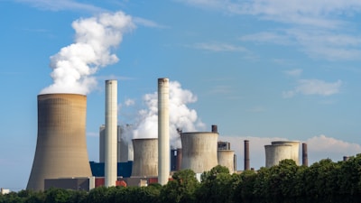 Cluster of industrial smokestacks against an overcast sky