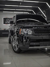 A shiny used car freshly detailed under bright showroom lights at Roya Auto.