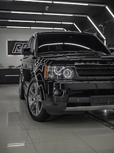 A shiny used car freshly detailed under bright showroom lights at Roya Auto.