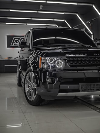 A stunning display of luxury cars including a Range Rover.