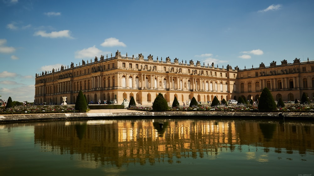 a large building with a pond in front of it