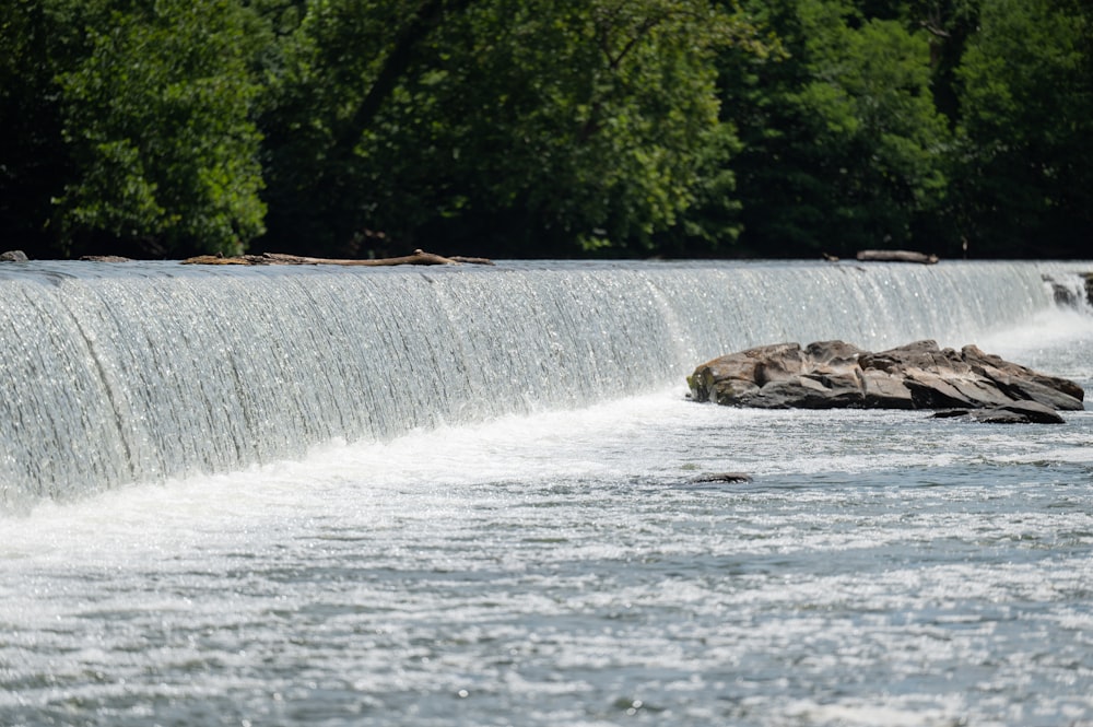 a waterfall with trees in the background