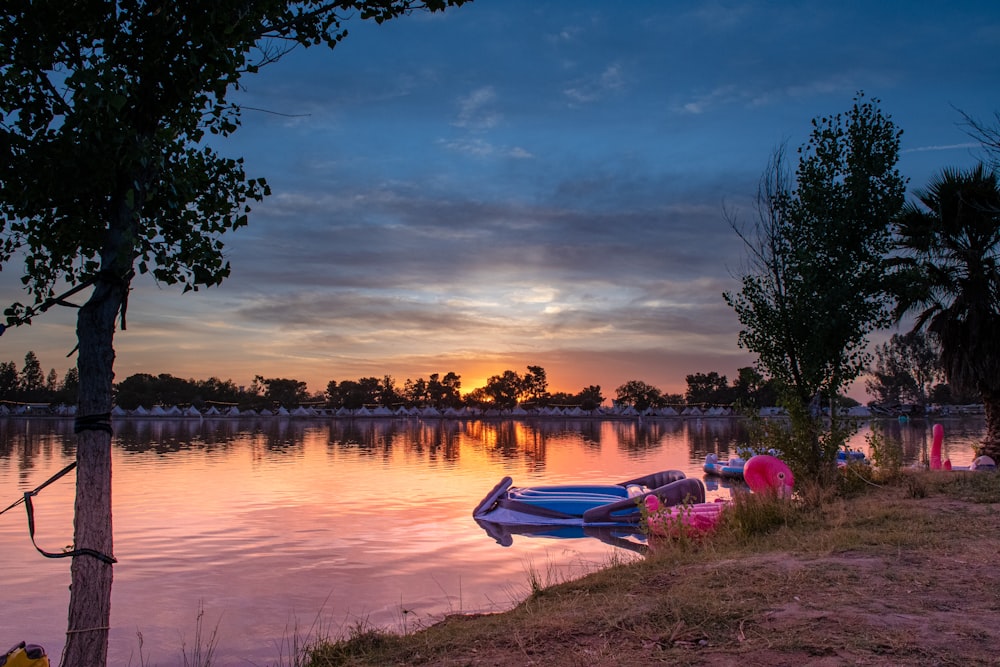 a body of water with boats on it and trees around it