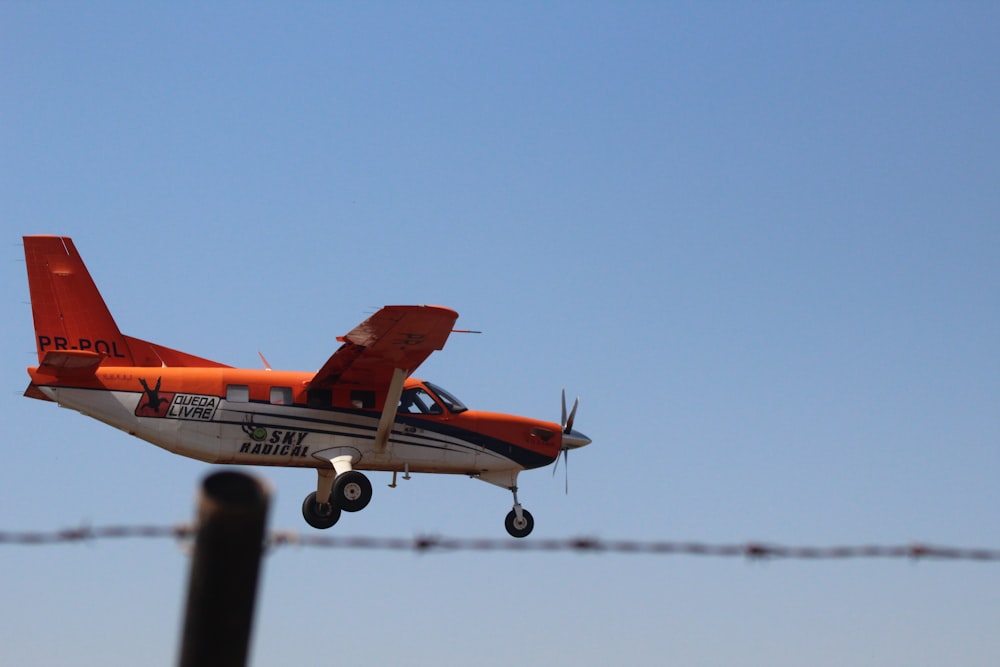 an orange plane flying