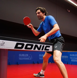 a man playing ping pong