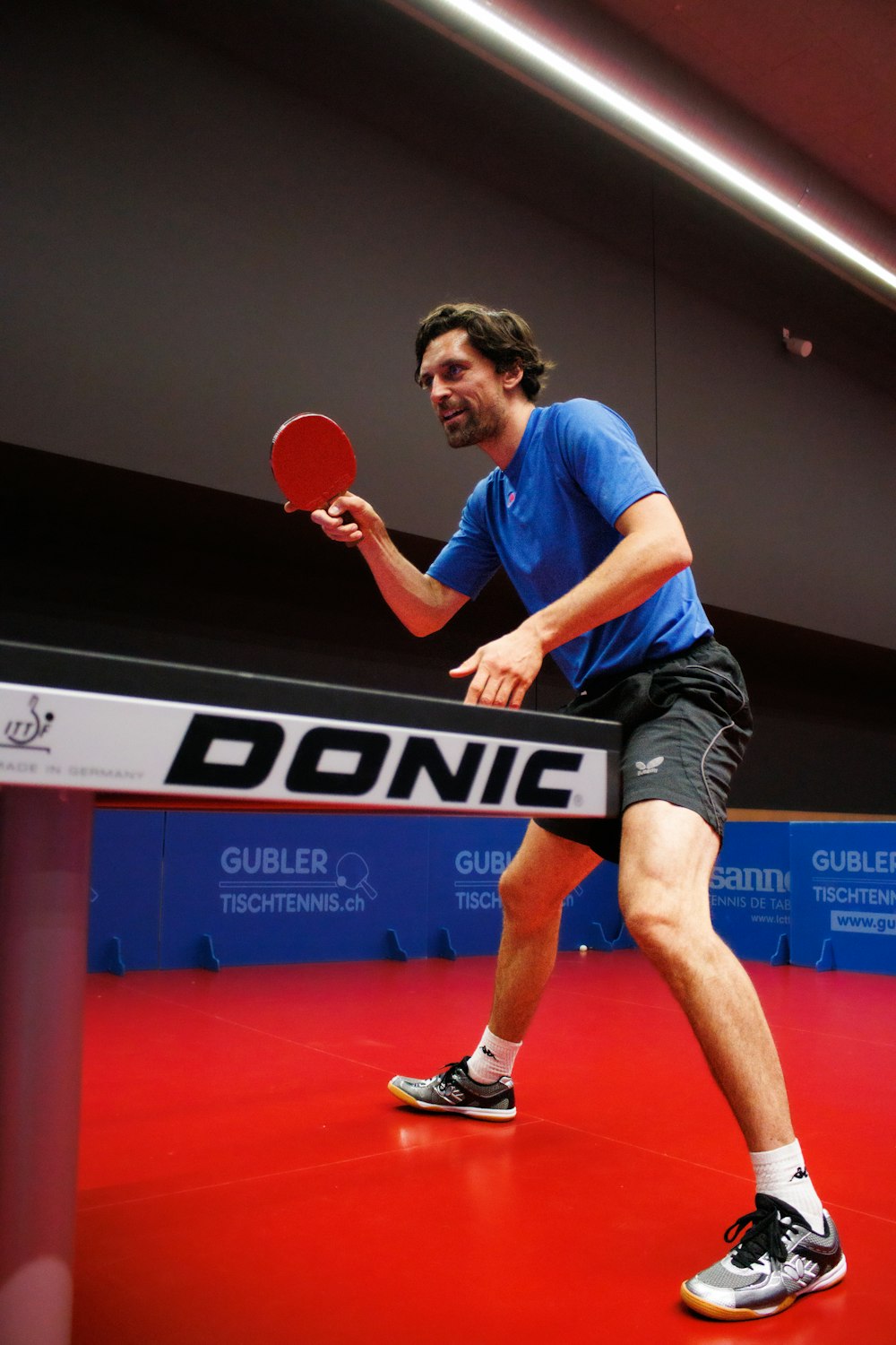 a man playing ping pong