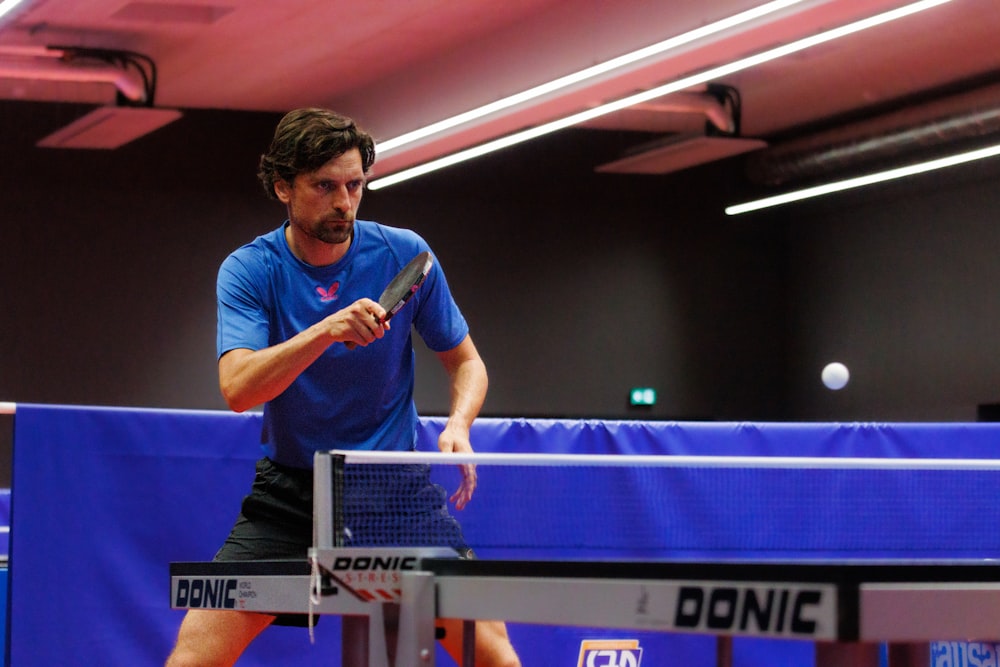 a man playing ping pong