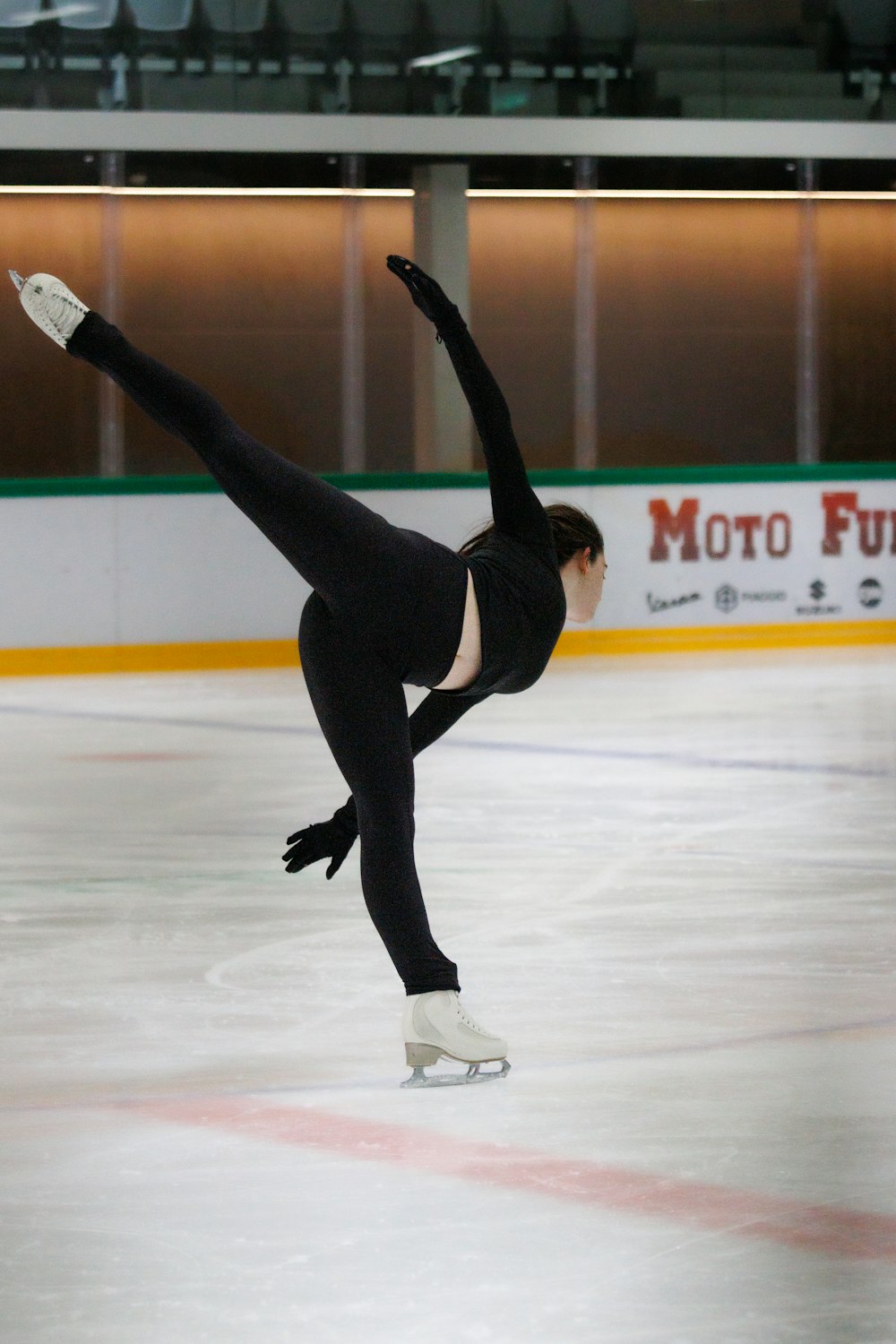 a person doing a handstand on an ice rink
