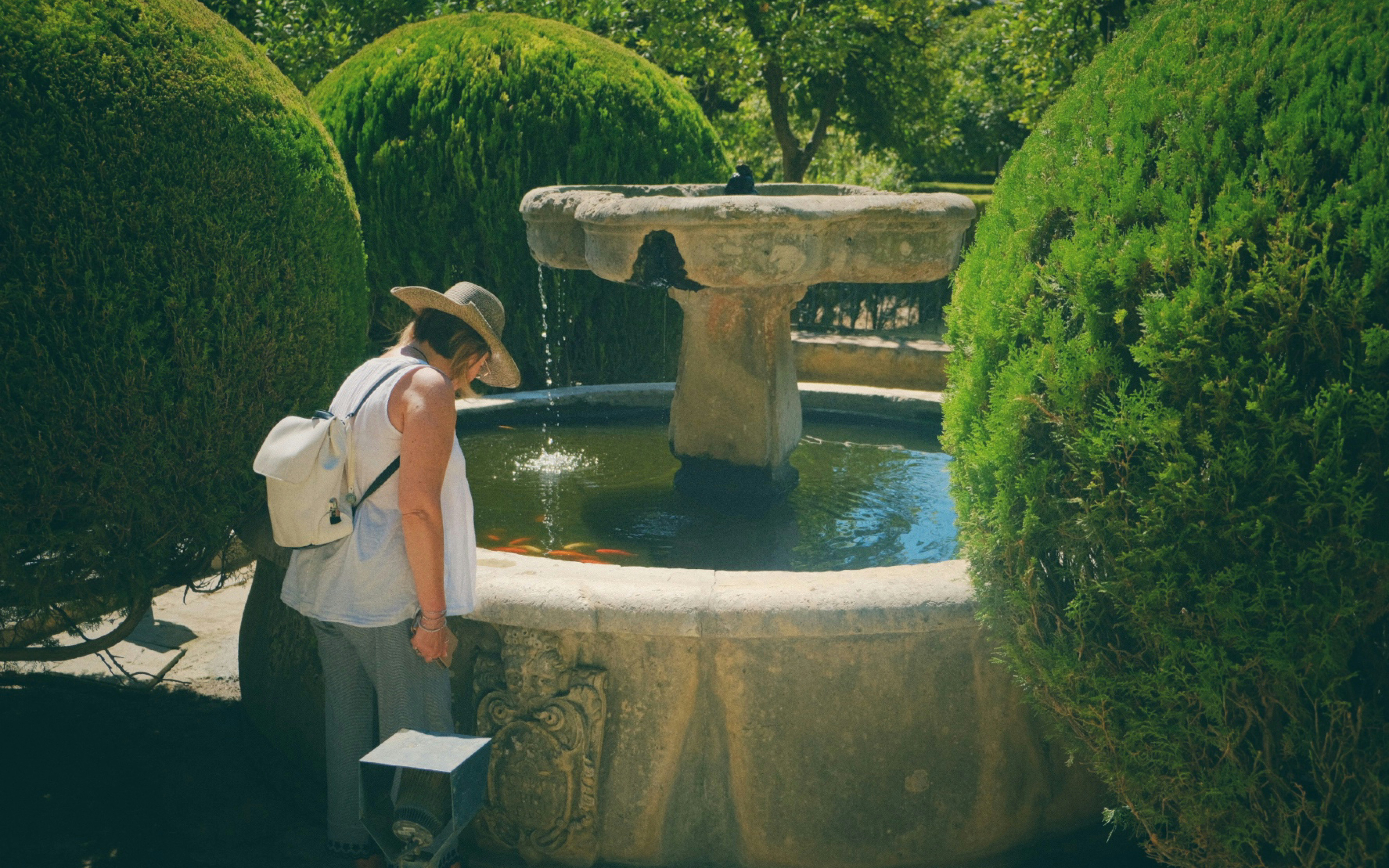 a person standing next to a fountain