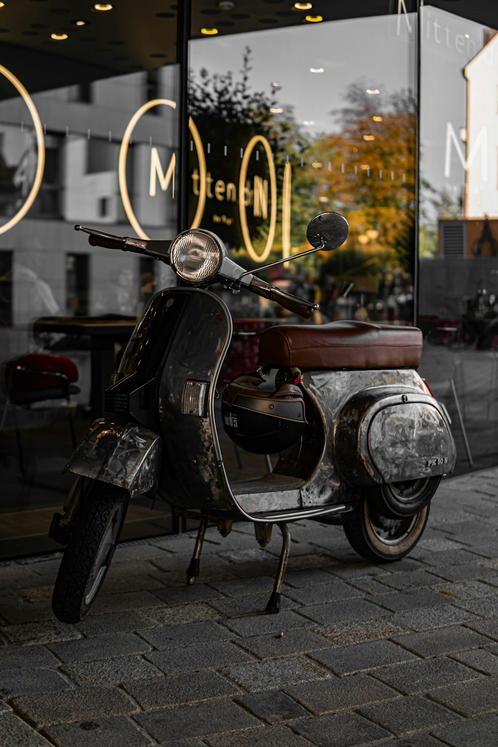 a motorcycle parked in front of a store window