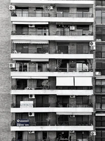 A friendly real estate agent from Balaji Capital discussing property options with clients.