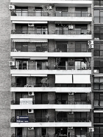 A friendly real estate agent from Balaji Capital discussing property options with clients.