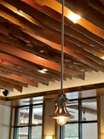 Contemporary ceiling light with wooden accents in a bright, modern kitchen.