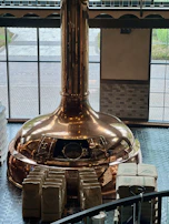 A scenic view of the brewery’s copper kettles steaming gently in the brewing room.