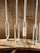 Several narrow glass tubes with varying amounts of granular material are mounted vertically on a wooden base. Each tube features measurement marks, suggesting a scientific or laboratory setting.