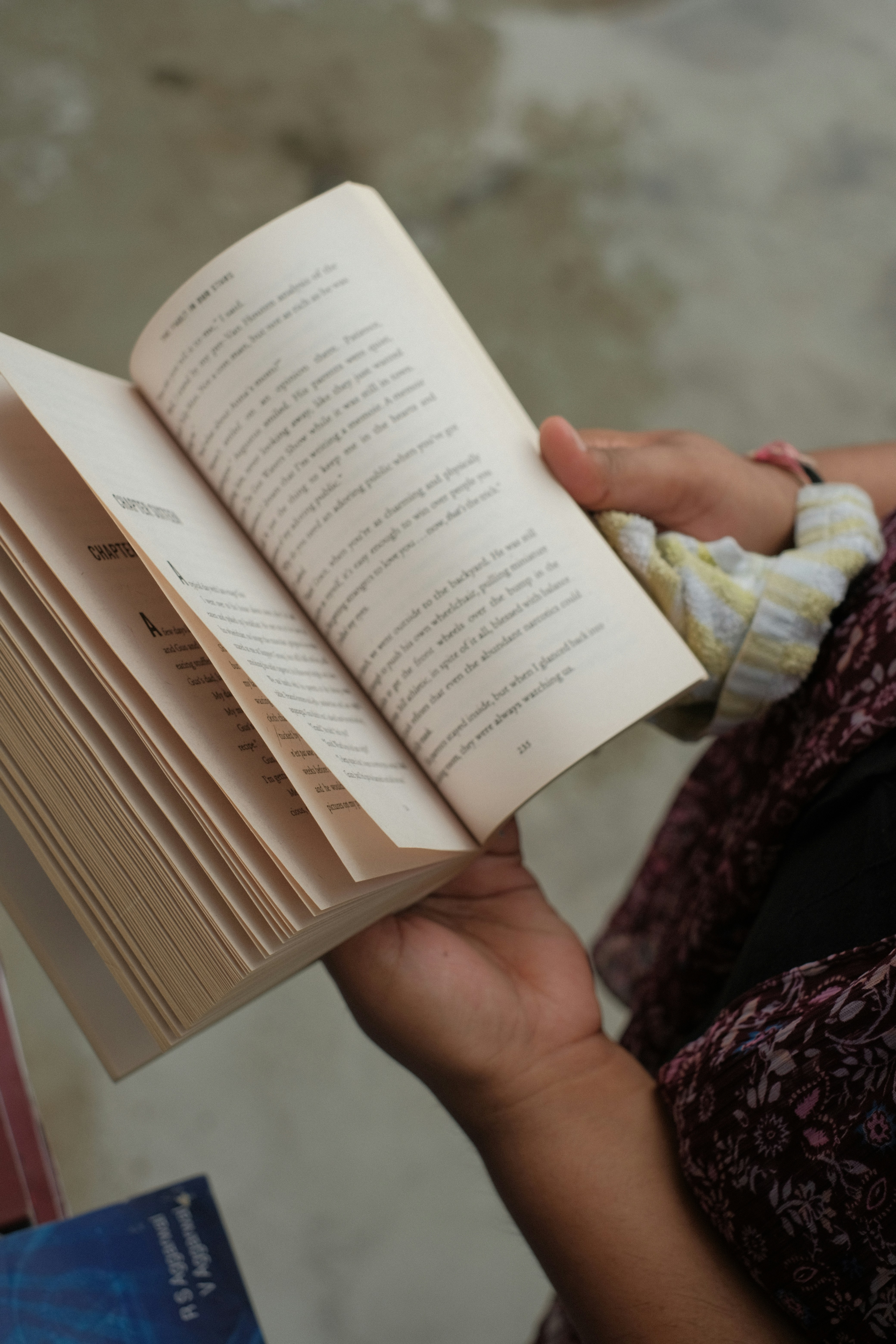a hand holding a book