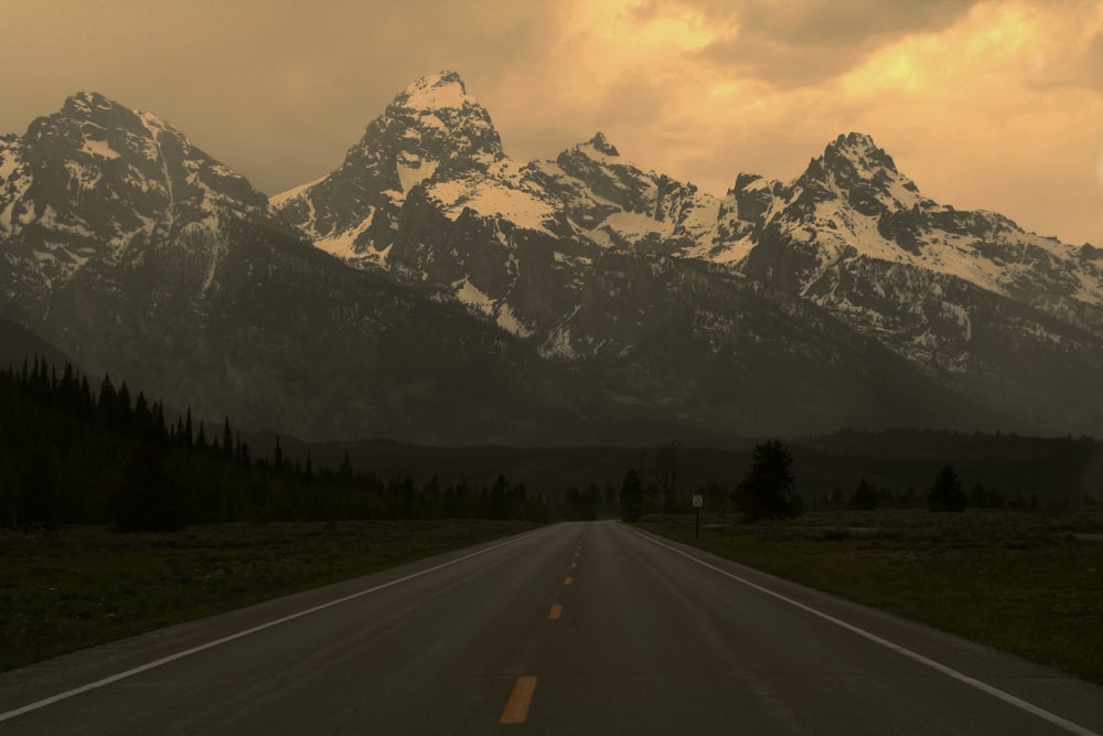 a road with snow covered mountains