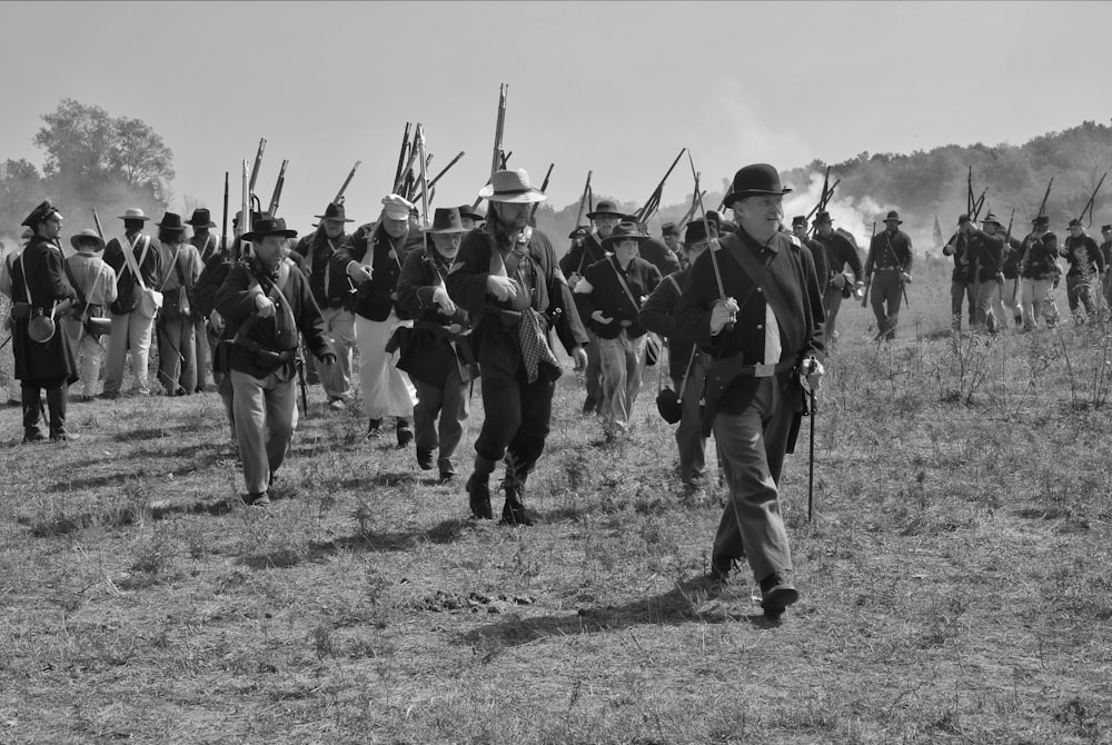 a group of men in military uniforms marching in a field