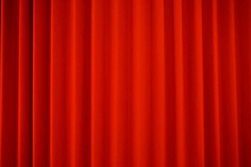 a red curtain with a black border