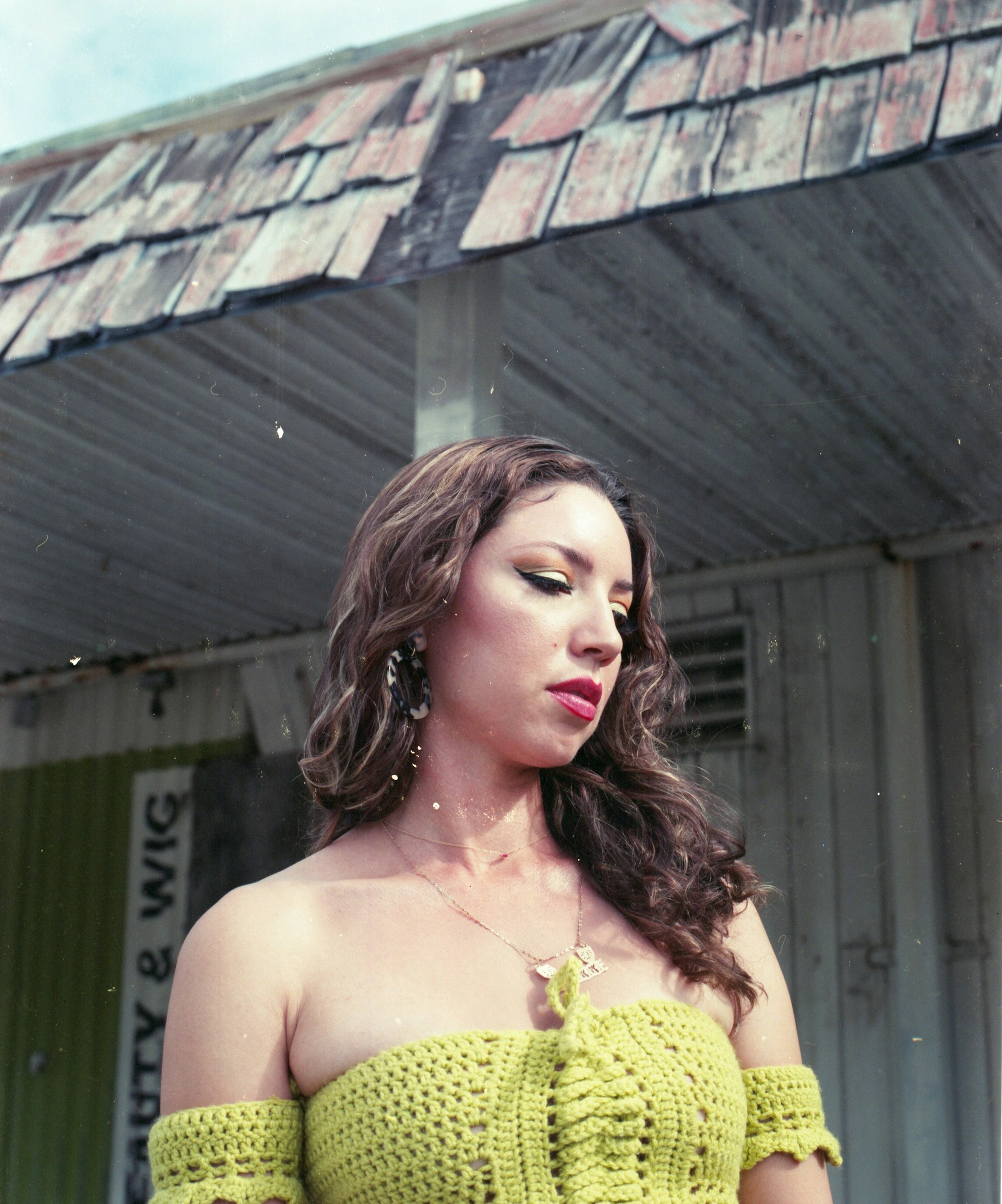 woman wearing yellow long-sleeved dress under white clouds and blue sky during daytime