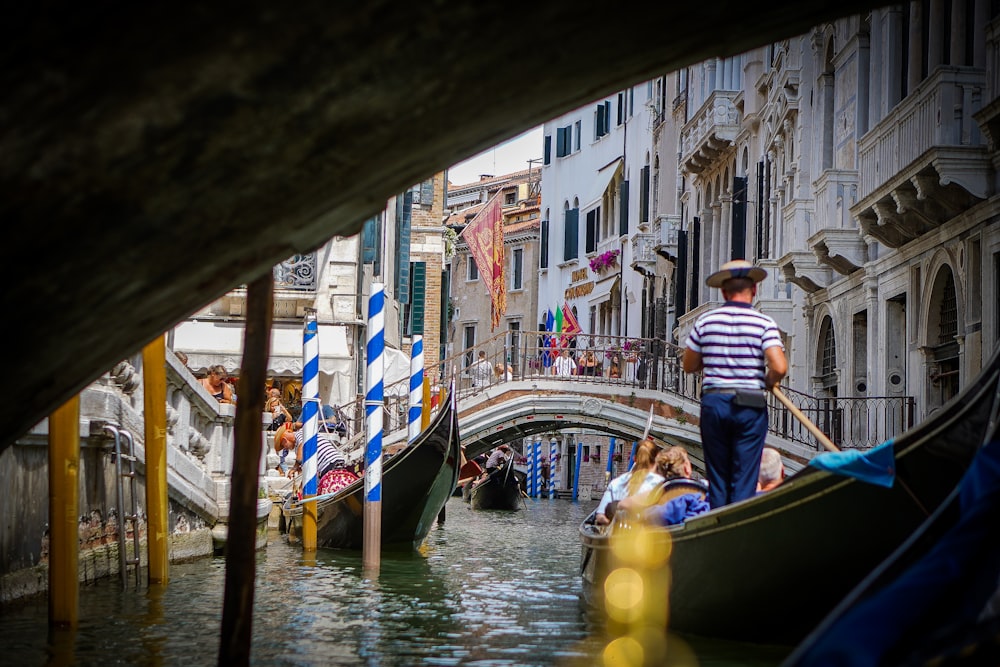 a person standing on a boat in a canal