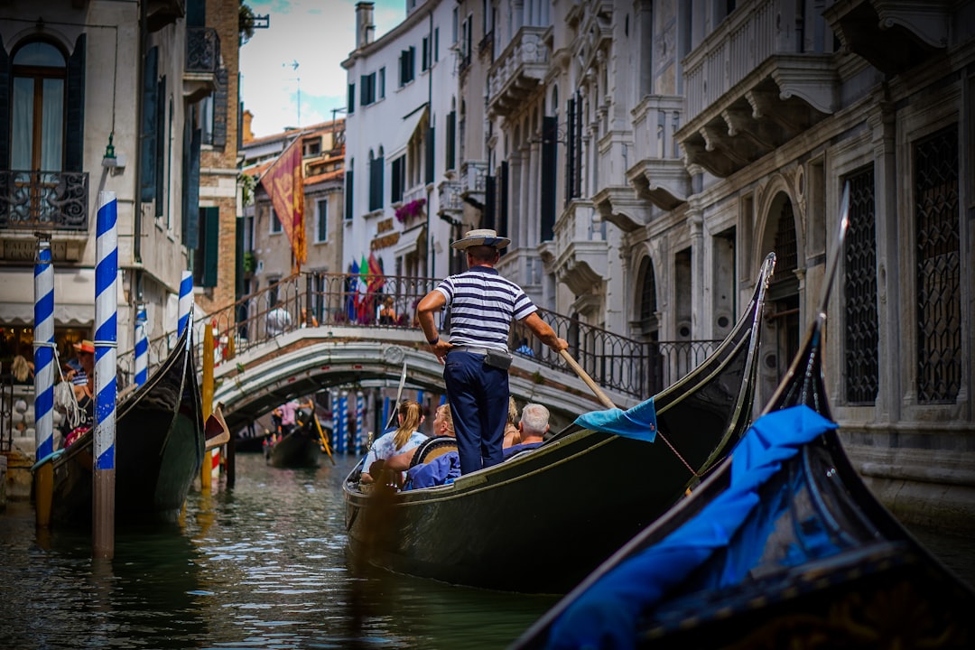 a person on a boat in a canal,