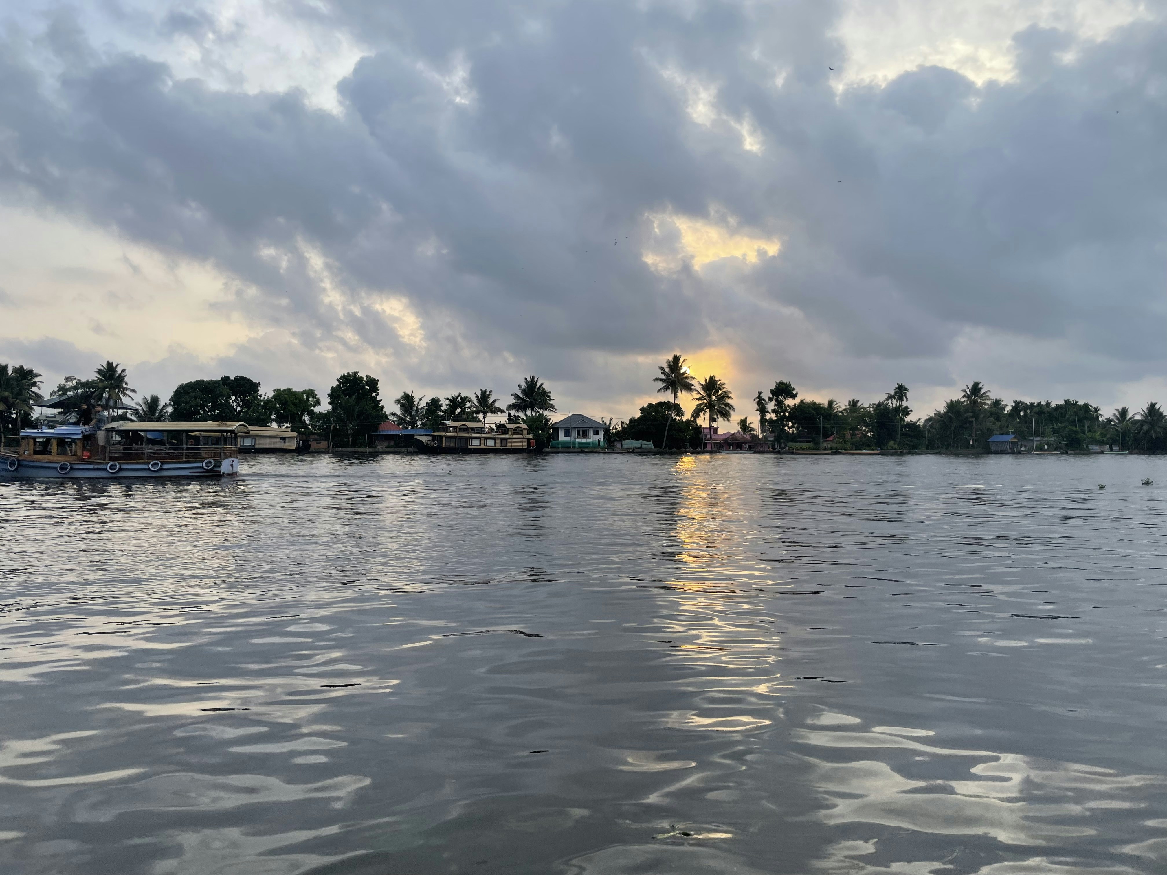 a body of water with buildings and trees in the background