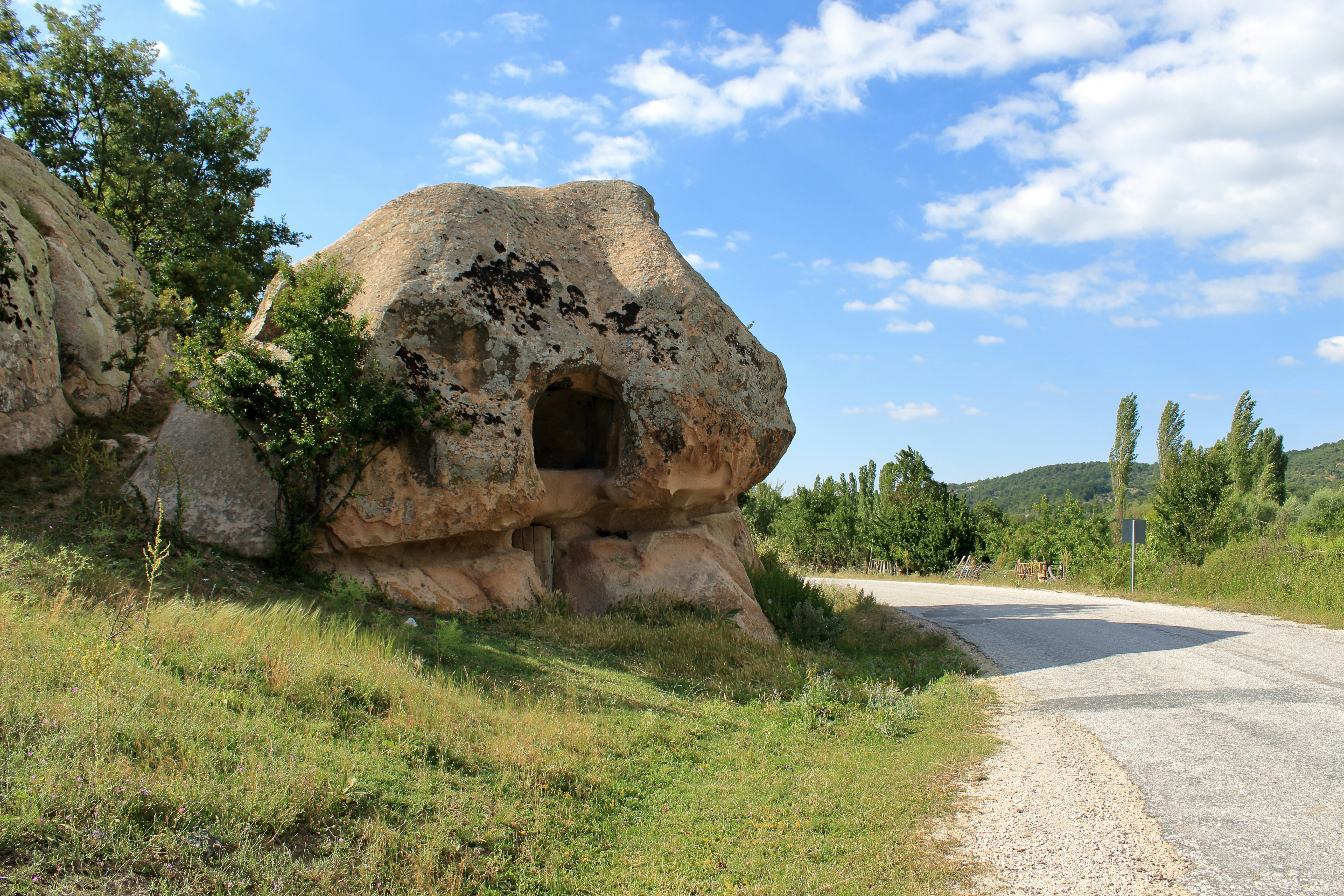 a rock formation on the side of a road