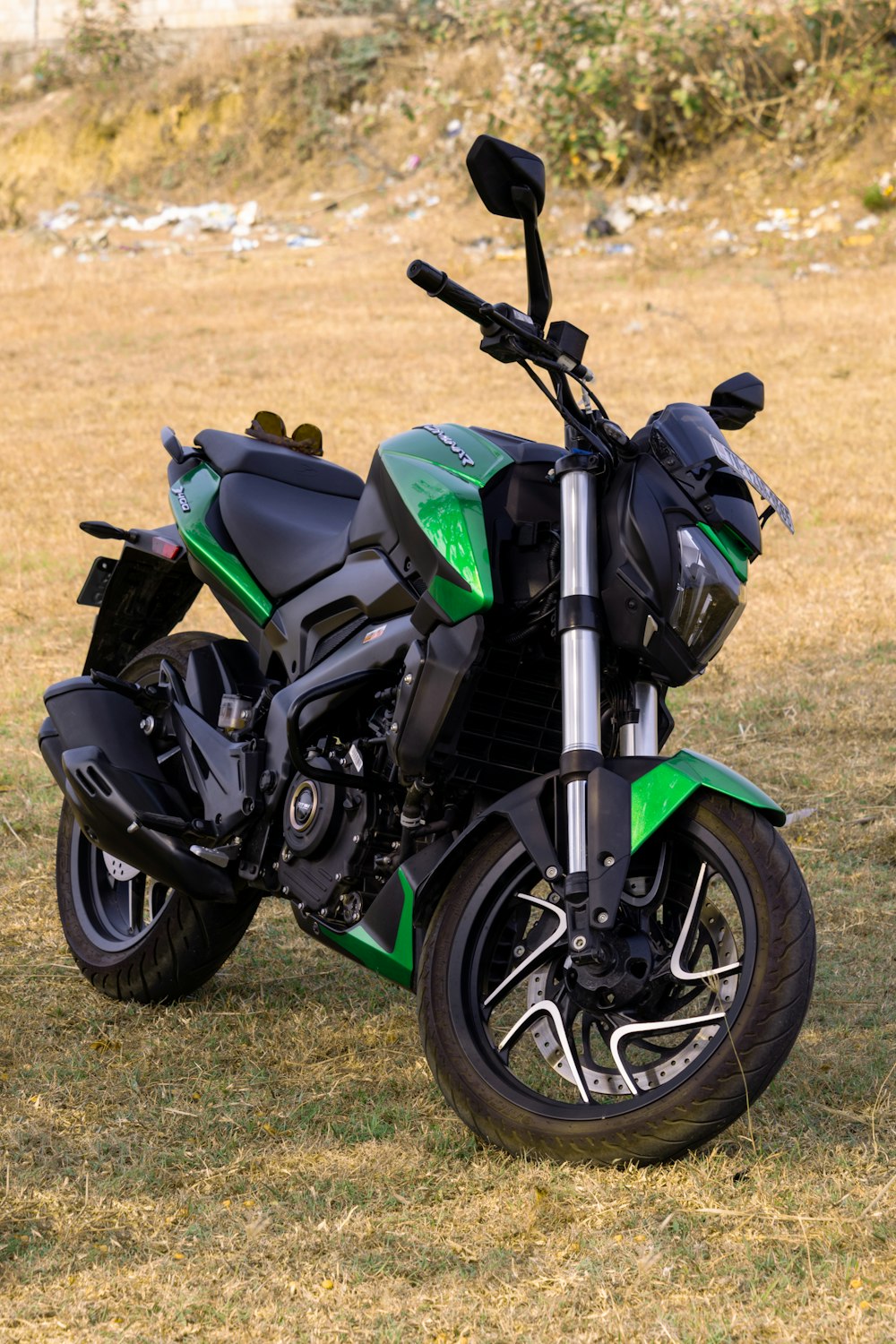 a green motorcycle parked on grass