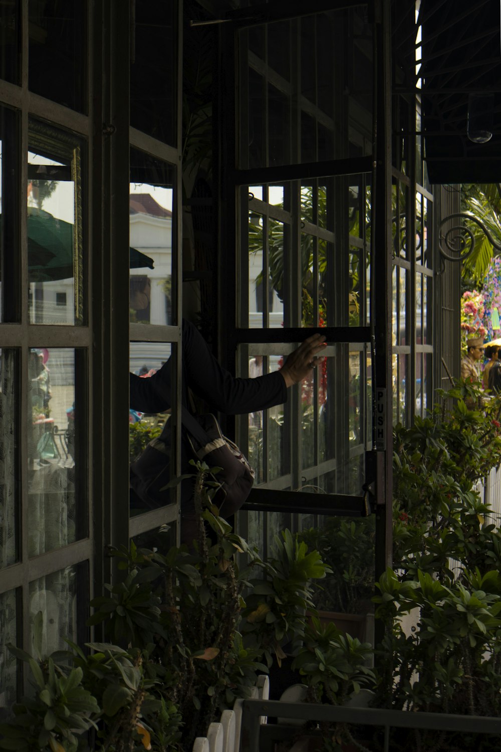 a person climbing a glass wall