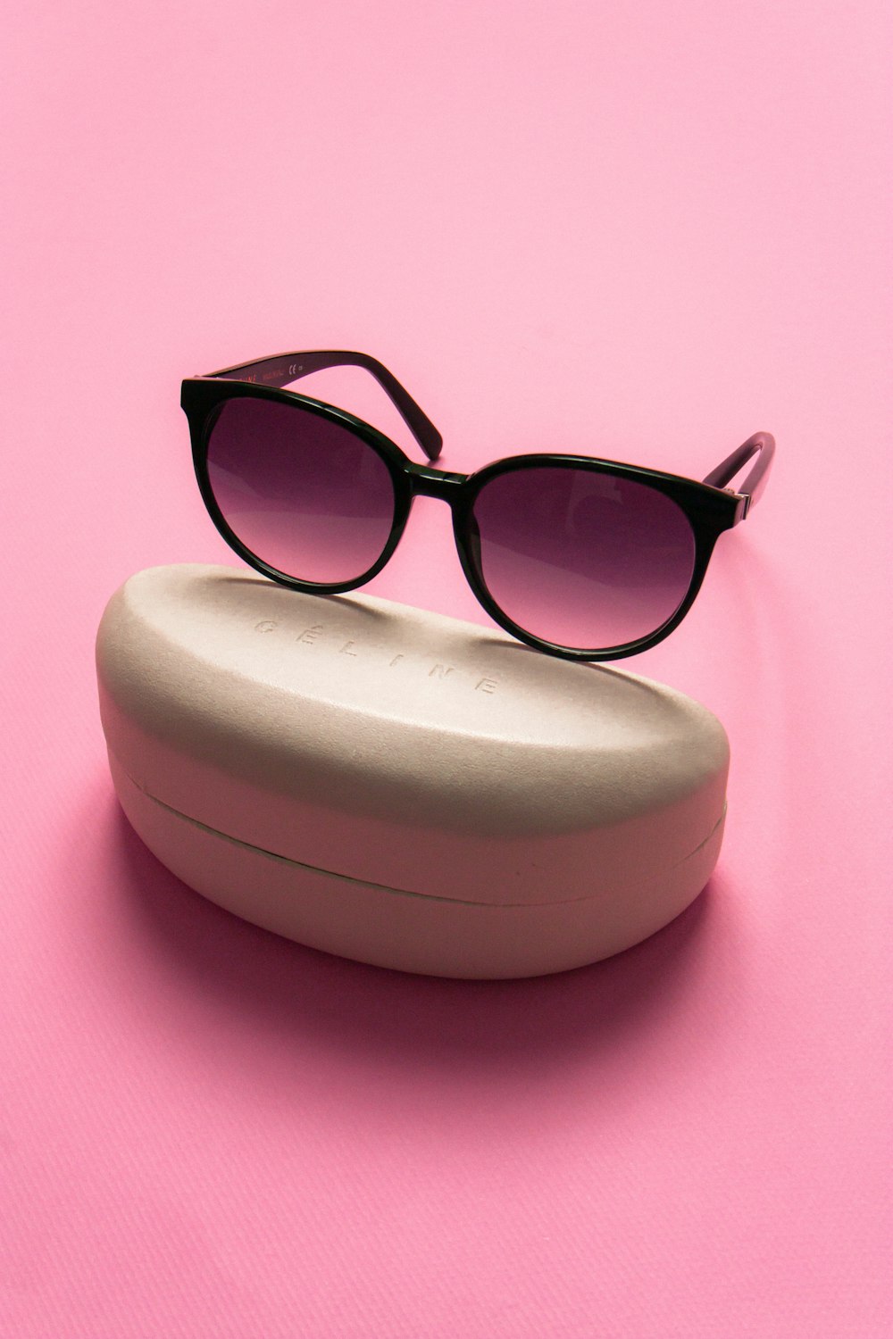 a pair of sunglasses on a white bowl