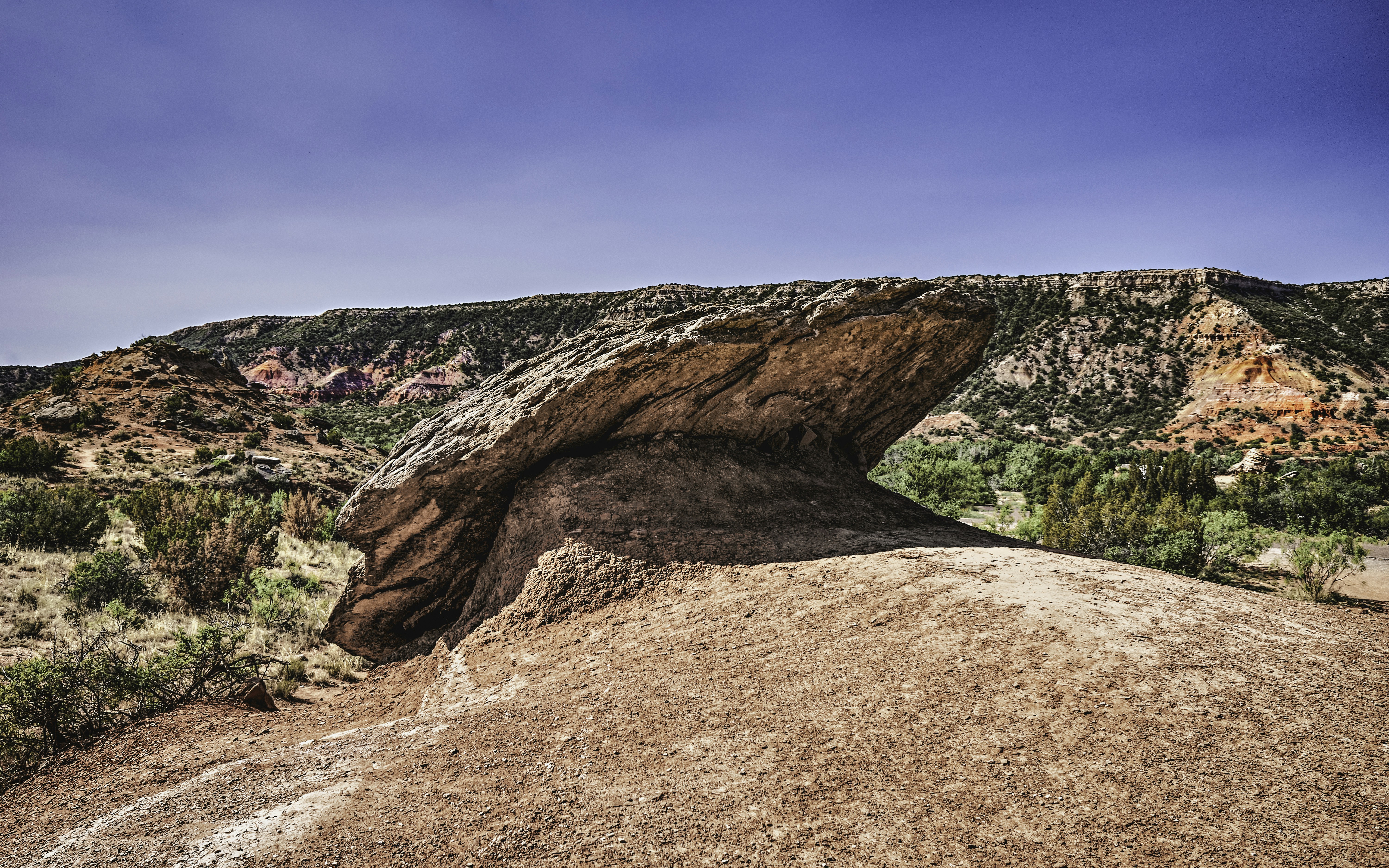 a large rock formation in the middle of a desert