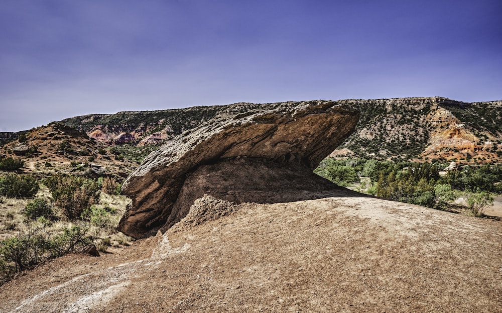 a large rock formation in the middle of a desert