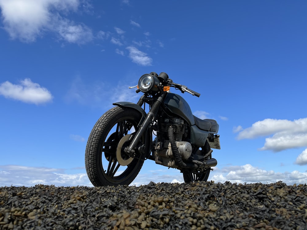 a motorcycle parked on a rocky hill
