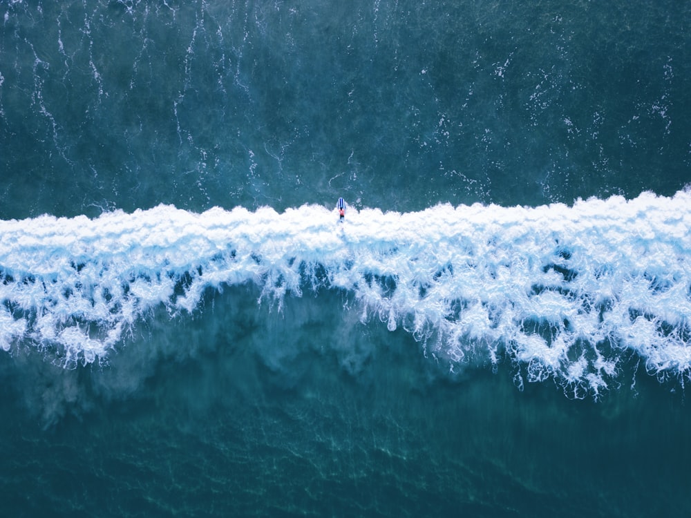 a person surfing on a wave