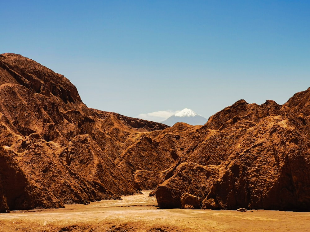 a rocky mountain with a blue sky