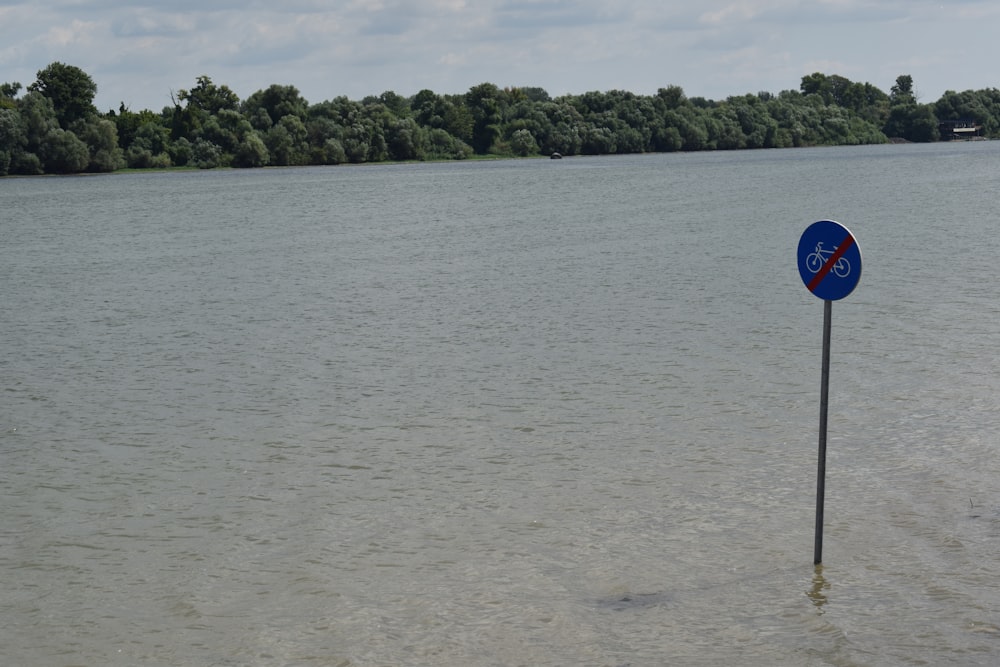 a sign in the middle of a lake