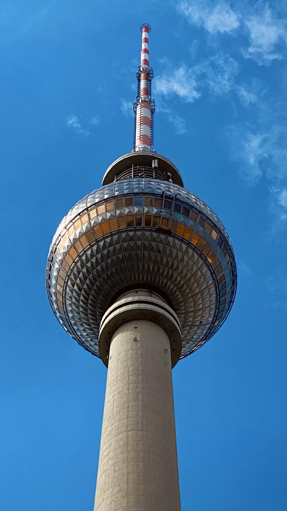 a tall tower with a circular top with Fernsehturm Berlin in the background